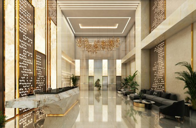 Lobby moderno de un hotel de lujo, con recepción de mármol, detalles dorados, una lámpara de diseño y un sector de sillones